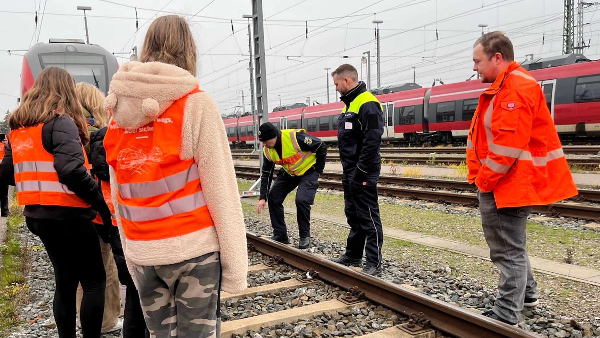 Das Präventionsteam erklärt den Schülern etwas am Gleis.